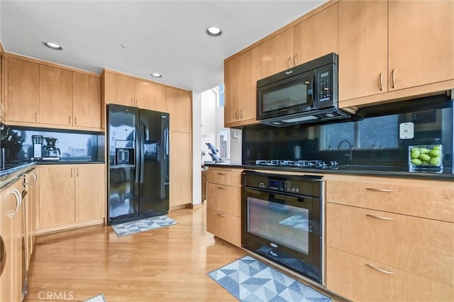 16745 Bayview Dr Unit B, Sunset Beach, CA 90742 - kitchen featuring black appliances, dark countertops, light wood finished floors, decorative backsplash, and recessed lighting
