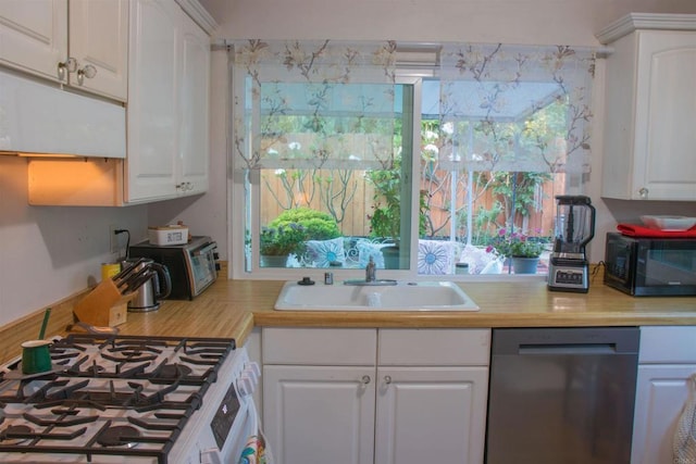 1682 Saddlehorn Dr, San Marcos, CA 92069 - kitchen with dishwasher, black microwave, white gas stove, light countertops, and white cabinetry