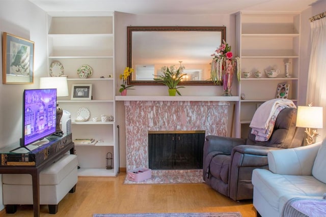 1682 Saddlehorn Dr, San Marcos, CA 92069 - living room featuring wood finished floors, a premium fireplace, and built in features