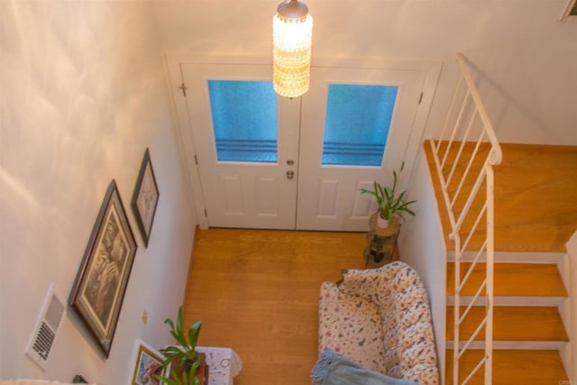 1682 Saddlehorn Dr, San Marcos, CA 92069 - doorway to outside featuring stairway, wood finished floors, and a chandelier