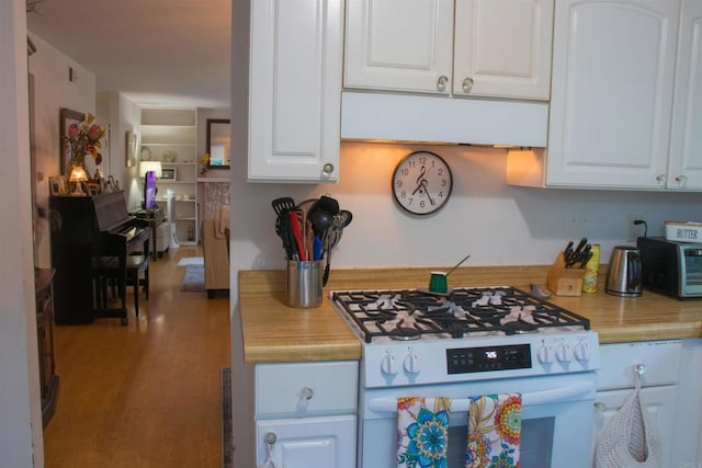 1682 Saddlehorn Dr, San Marcos, CA 92069 - kitchen with white gas stove, light countertops, white cabinetry, and wood finished floors