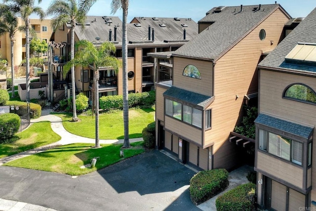 4015 Canario St Unit E, Carlsbad, CA 92008 - view of property featuring an attached garage, driveway, and a residential view