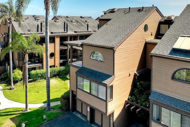 4015 Canario St Unit E, Carlsbad, CA 92008 - view of building exterior featuring an attached garage and asphalt driveway