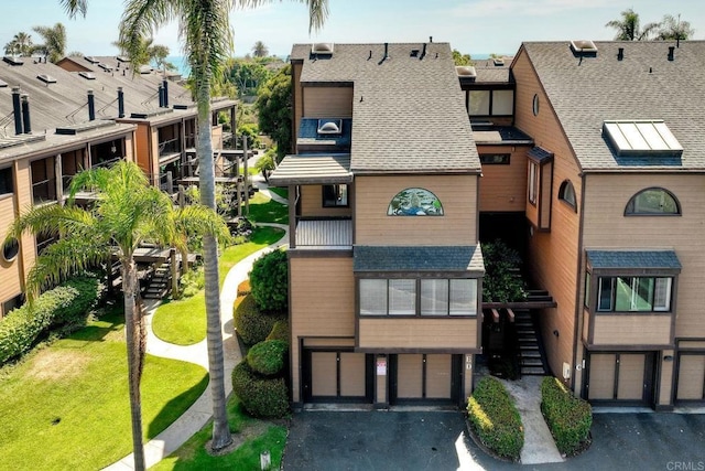 4015 Canario St Unit E, Carlsbad, CA 92008 - view of building exterior with driveway, a garage, and stairway