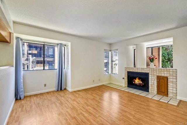 4015 Canario St Unit E, Carlsbad, CA 92008 - unfurnished living room with light wood finished floors and a fireplace
