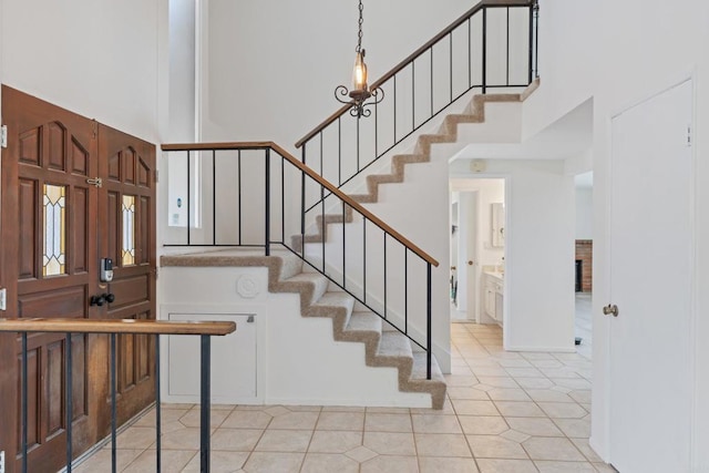 6174 Syracuse Way, San Diego, CA 92122 - staircase with a towering ceiling and tile patterned floors