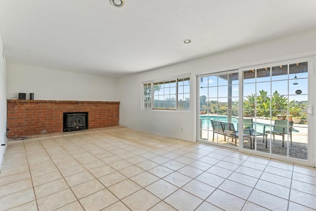 6174 Syracuse Way, San Diego, CA 92122 - unfurnished living room featuring light tile patterned flooring and a wood stove