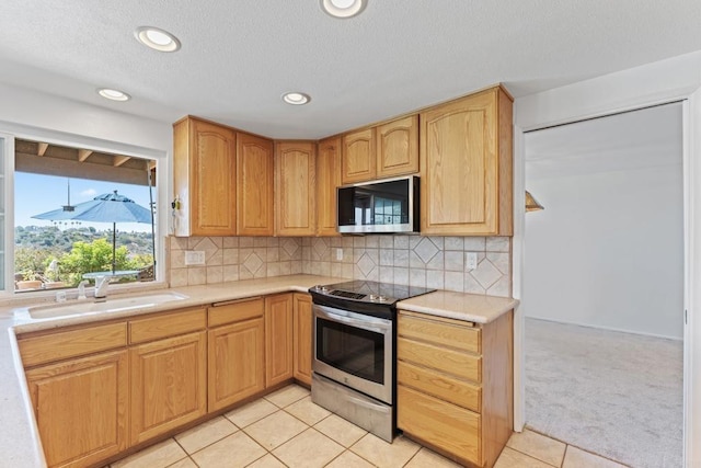 6174 Syracuse Way, San Diego, CA 92122 - kitchen with appliances with stainless steel finishes, light countertops, light colored carpet, light tile patterned floors, and recessed lighting