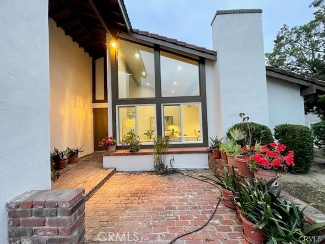 16413 Abascal Dr, Hacienda Heights, CA 91745 - rear view of property with stucco siding, a chimney, and a patio area
