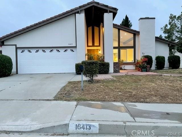 16413 Abascal Dr, Hacienda Heights, CA 91745 - mid-century home featuring driveway, a garage, a chimney, and stucco siding