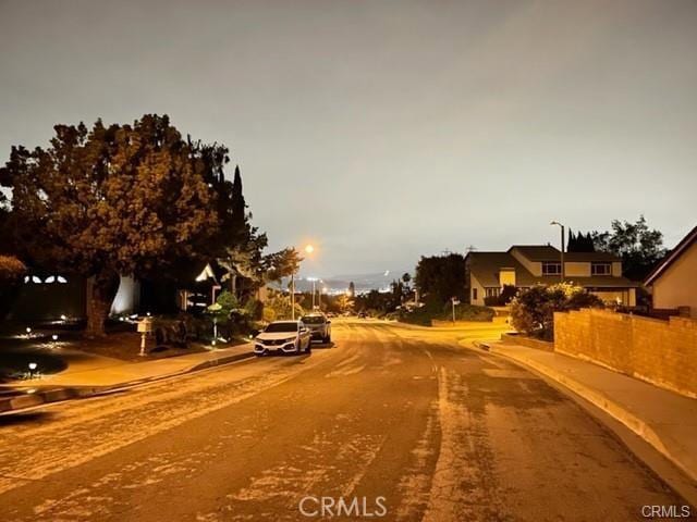 16413 Abascal Dr, Hacienda Heights, CA 91745 - view of asphalt street with street lighting, sidewalks, and curbs
