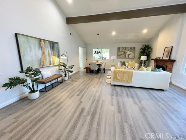 16413 Abascal Dr, Hacienda Heights, CA 91745 - living room featuring wood finished floors, beam ceiling, a chandelier, a fireplace, and recessed lighting