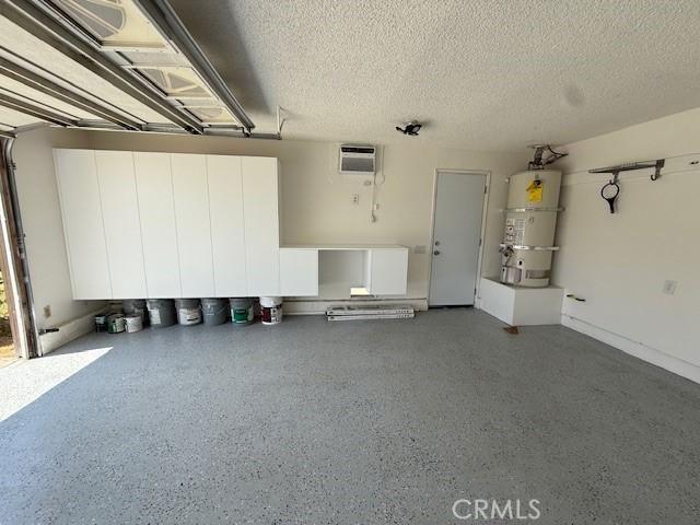 16413 Abascal Dr, Hacienda Heights, CA 91745 - garage featuring strapped water heater and a wall mounted air conditioner