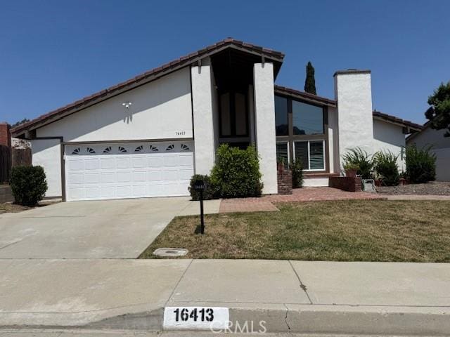 16413 Abascal Dr, Hacienda Heights, CA 91745 - mid-century inspired home with concrete driveway, stucco siding, a garage, and a front yard