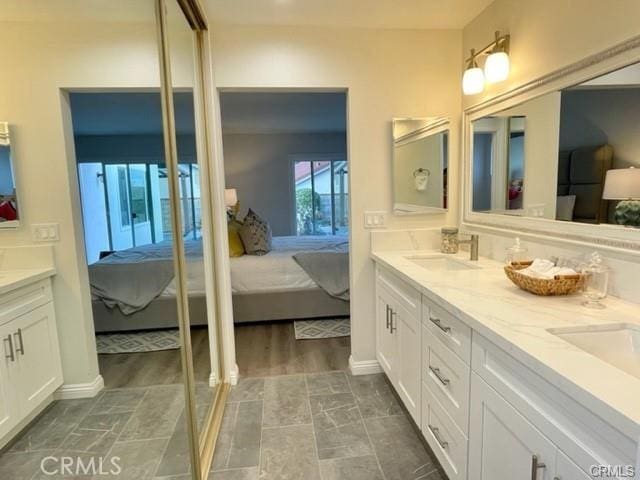 16413 Abascal Dr, Hacienda Heights, CA 91745 - ensuite bathroom featuring double vanity and baseboards