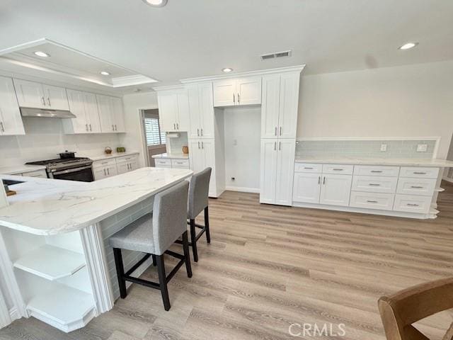 16413 Abascal Dr, Hacienda Heights, CA 91745 - kitchen featuring stainless steel gas range oven, white cabinets, light wood-type flooring, recessed lighting, and open shelves