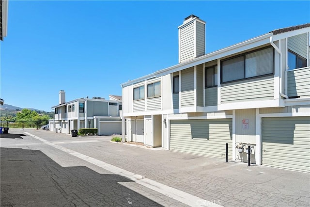 27074 Hidaway Ave Unit 3, Canyon Country, CA 91351 - view of building exterior with an attached garage