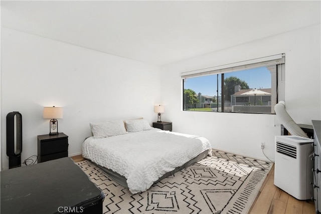 27074 Hidaway Ave Unit 3, Canyon Country, CA 91351 - bedroom with baseboards and light wood-style floors