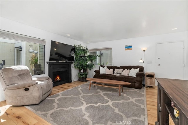 27074 Hidaway Ave Unit 3, Canyon Country, CA 91351 - living room with light wood-style floors and a warm lit fireplace