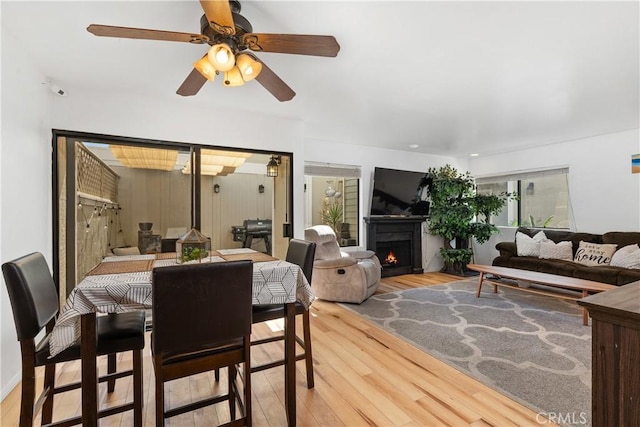 27074 Hidaway Ave Unit 3, Canyon Country, CA 91351 - dining space with wood finished floors, a warm lit fireplace, and ceiling fan