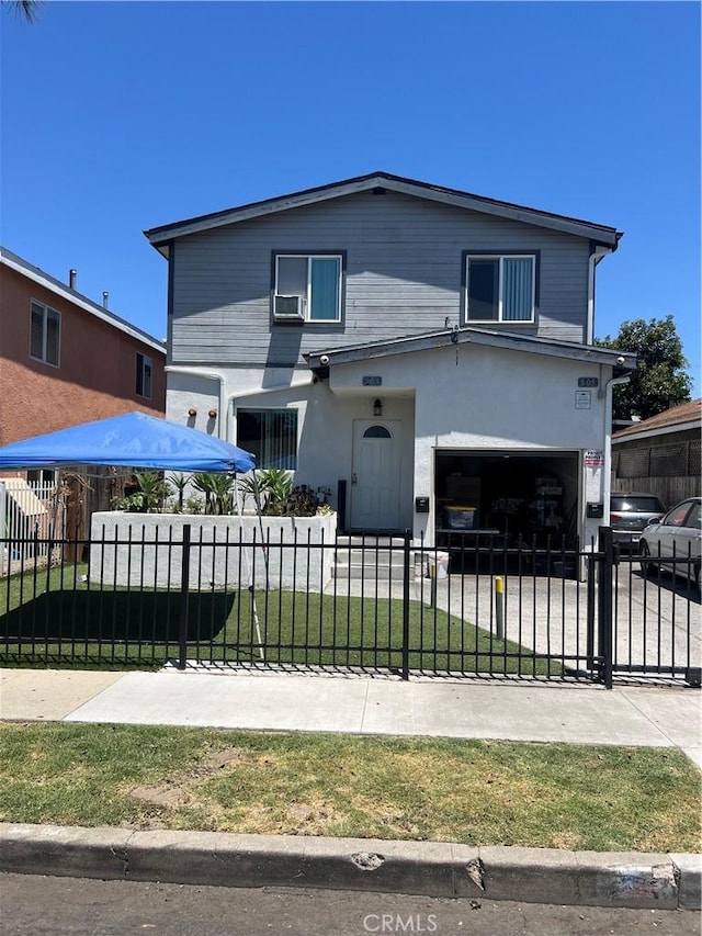 505 E 68th St, Los Angeles, CA 90003 - view of front of home with a garage, a fenced front yard, driveway, and stucco siding