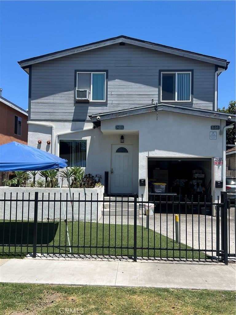505 E 68th St, Los Angeles, CA 90003 - view of front of home with a garage, a fenced front yard, stucco siding, and cooling unit