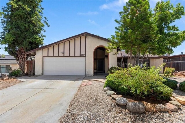 1897 Taylor Ave, Corona, CA 92882 - ranch-style home with concrete driveway, a garage, board and batten siding, and stucco siding