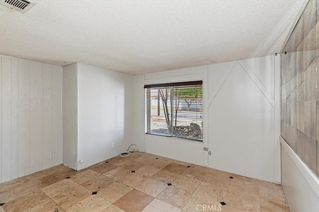 1897 Taylor Ave, Corona, CA 92882 - unfurnished room featuring a textured ceiling and wood walls