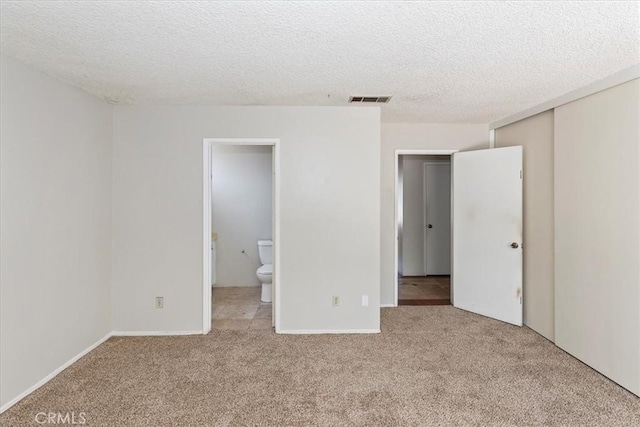 1897 Taylor Ave, Corona, CA 92882 - unfurnished bedroom with carpet flooring, a textured ceiling, a closet, and ensuite bath