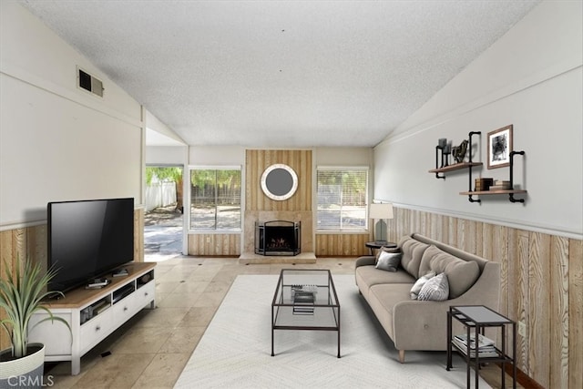 1897 Taylor Ave, Corona, CA 92882 - living area with a textured ceiling, a wainscoted wall, a large fireplace, lofted ceiling, and light tile patterned flooring