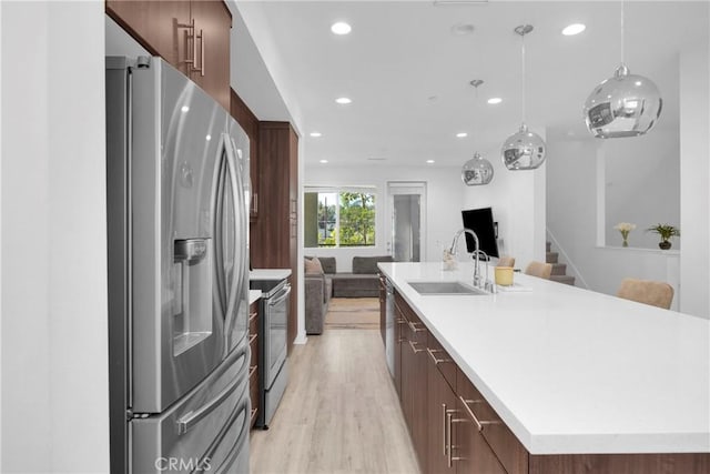 9958 Artesia Blvd Unit 1003, Bellflower, CA 90706 - kitchen with appliances with stainless steel finishes, recessed lighting, a large island, modern cabinets, and light wood finished floors