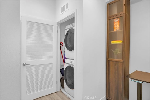 9958 Artesia Blvd Unit 1003, Bellflower, CA 90706 - laundry room featuring stacked washer / dryer and light wood-style floors