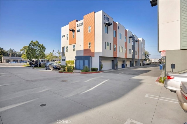 9958 Artesia Blvd Unit 1003, Bellflower, CA 90706 - view of building exterior featuring uncovered parking