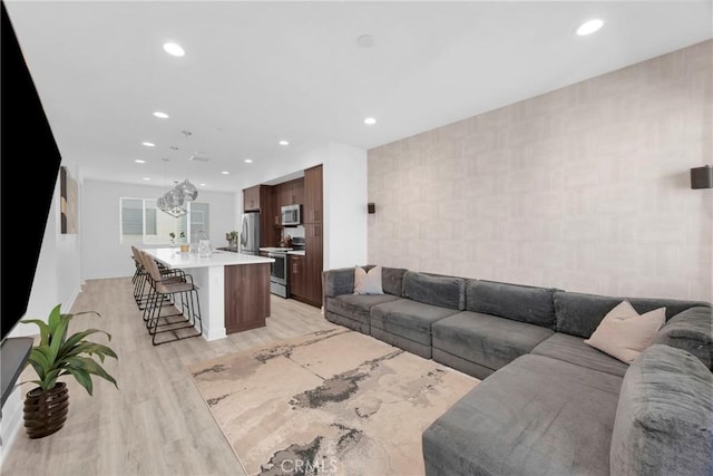9958 Artesia Blvd Unit 1003, Bellflower, CA 90706 - living area with light wood finished floors, recessed lighting, and tile walls