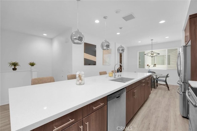 9958 Artesia Blvd Unit 1003, Bellflower, CA 90706 - kitchen with appliances with stainless steel finishes, light wood-style flooring, light countertops, and recessed lighting