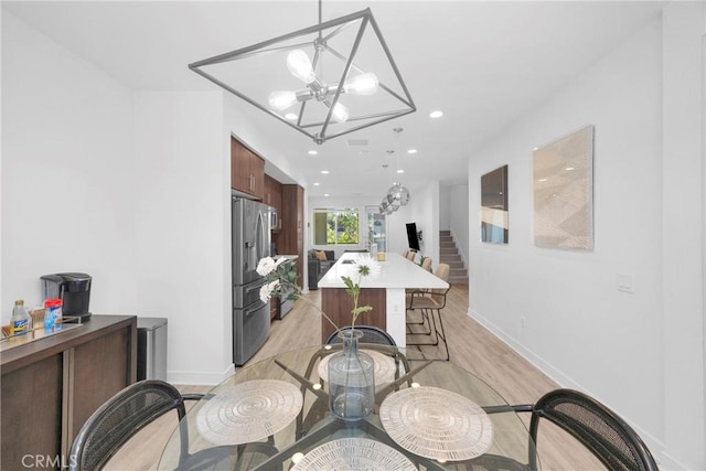 9958 Artesia Blvd Unit 1003, Bellflower, CA 90706 - dining area featuring a chandelier, light wood-type flooring, stairway, and recessed lighting