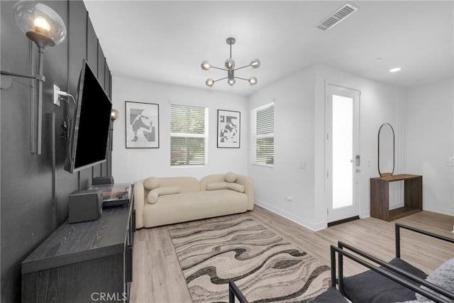 9958 Artesia Blvd Unit 1003, Bellflower, CA 90706 - living area featuring light wood-style floors and a chandelier