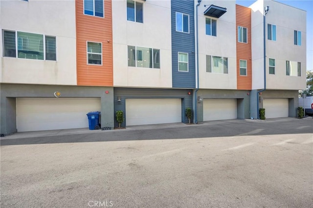 9958 Artesia Blvd Unit 1003, Bellflower, CA 90706 - view of front of property with stucco siding and a garage