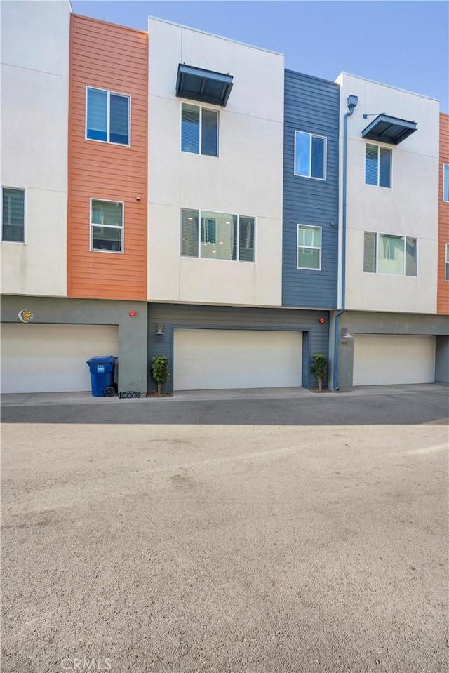 9958 Artesia Blvd Unit 1003, Bellflower, CA 90706 - view of building exterior with a garage