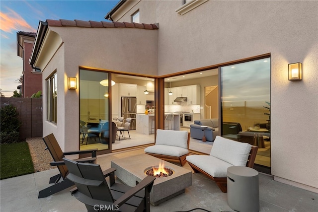 103 Winnett, Irvine, CA 92602 - patio terrace at dusk featuring a fire pit and a patio