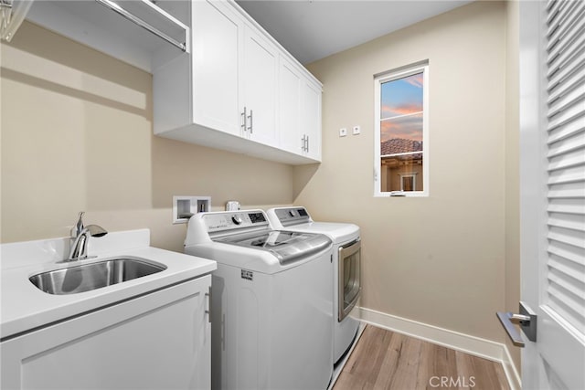 103 Winnett, Irvine, CA 92602 - laundry area featuring independent washer and dryer, cabinet space, and light wood-style floors