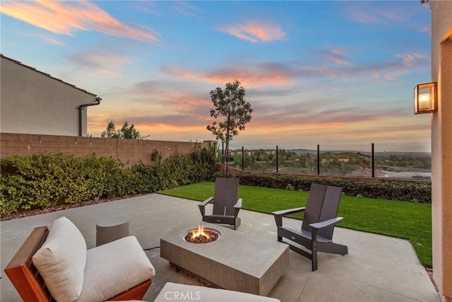 103 Winnett, Irvine, CA 92602 - patio terrace at dusk featuring a fire pit, a patio area, and a fenced backyard