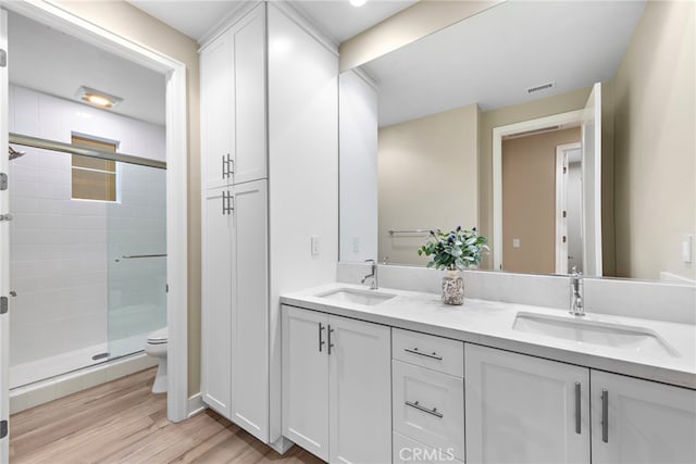 103 Winnett, Irvine, CA 92602 - full bath with double vanity, a shower stall, and wood finished floors