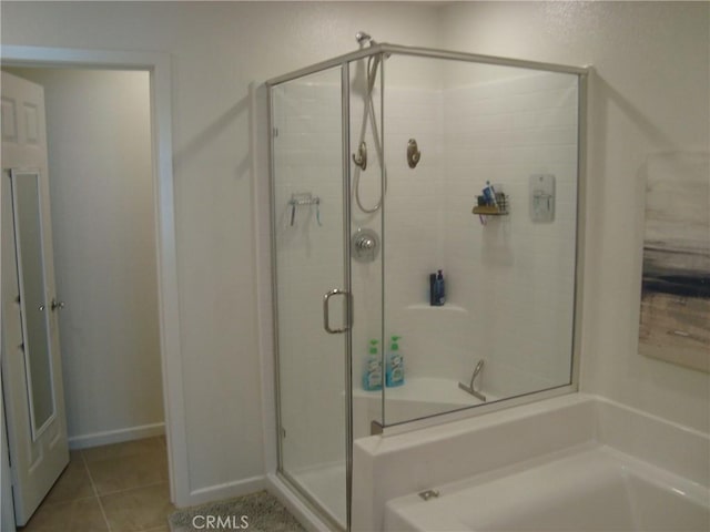 435 N Beechwood Ave, Rialto, CA 92376 - bathroom with a stall shower, tile patterned flooring, and a bath