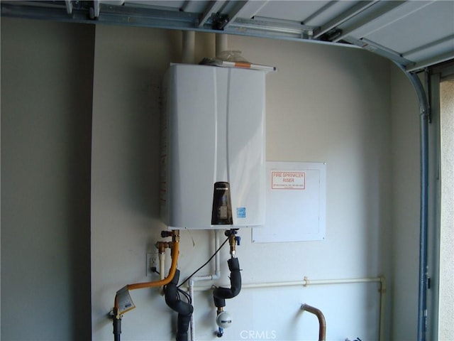 435 N Beechwood Ave, Rialto, CA 92376 - utility room featuring water heater and a garage