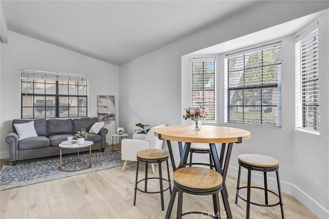 2633 Monte Carlo Dr Unit 41, Santa Ana, CA 92706 - dining room with light wood-style flooring and vaulted ceiling