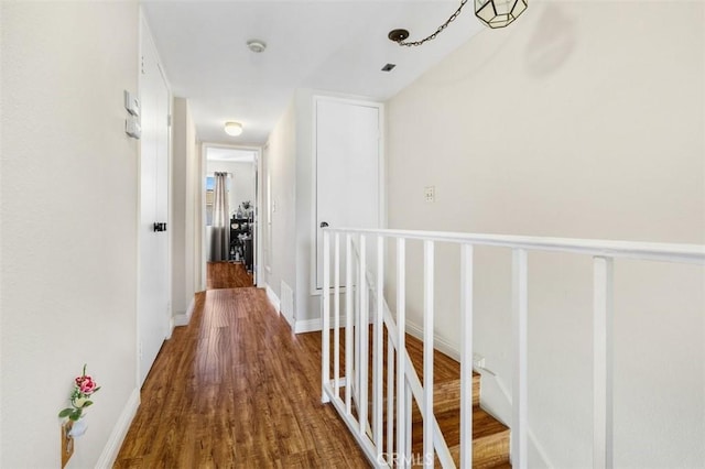 13725 Los Angeles St Unit H, Baldwin Park, CA 91706 - hallway featuring wood finished floors and an upstairs landing