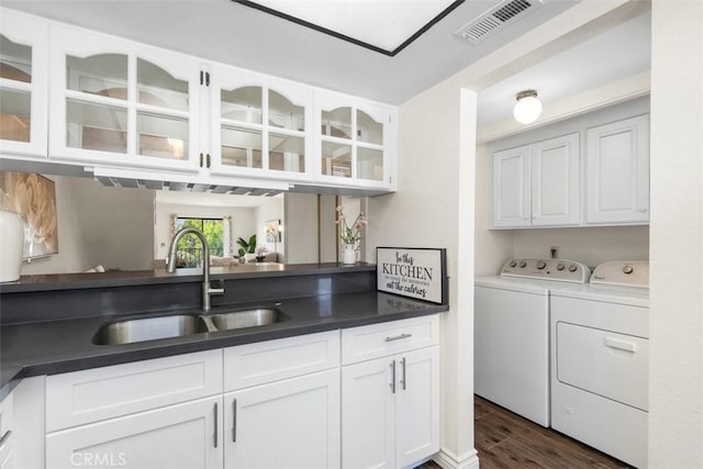 13725 Los Angeles St Unit H, Baldwin Park, CA 91706 - kitchen featuring washing machine and dryer, dark wood-style flooring, white cabinets, and glass insert cabinets