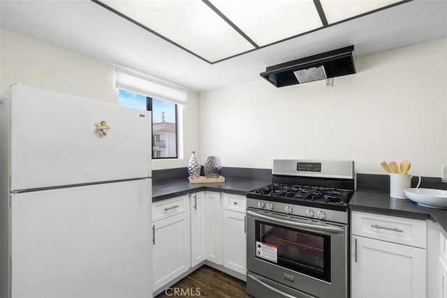 13725 Los Angeles St Unit H, Baldwin Park, CA 91706 - kitchen with freestanding refrigerator, stainless steel range with gas stovetop, dark countertops, and white cabinetry