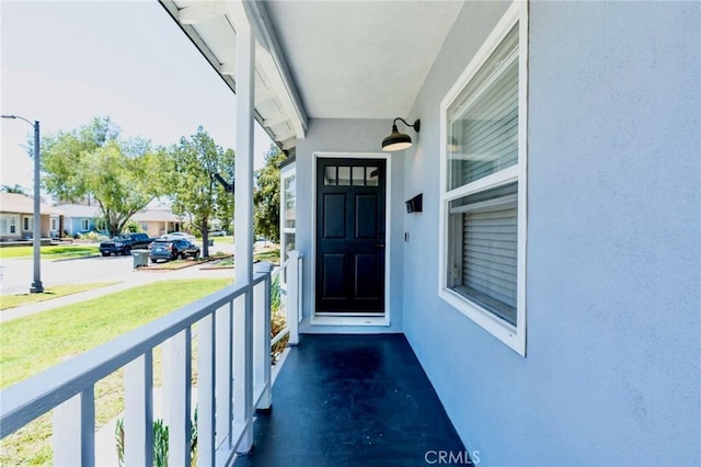 5855 Daneland St, Lakewood, CA 90713 - view of exterior entry with stucco siding and a porch